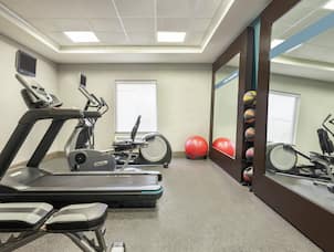 Convenient on-site fitness center for guests fully equipped with cardio machines and free weights.