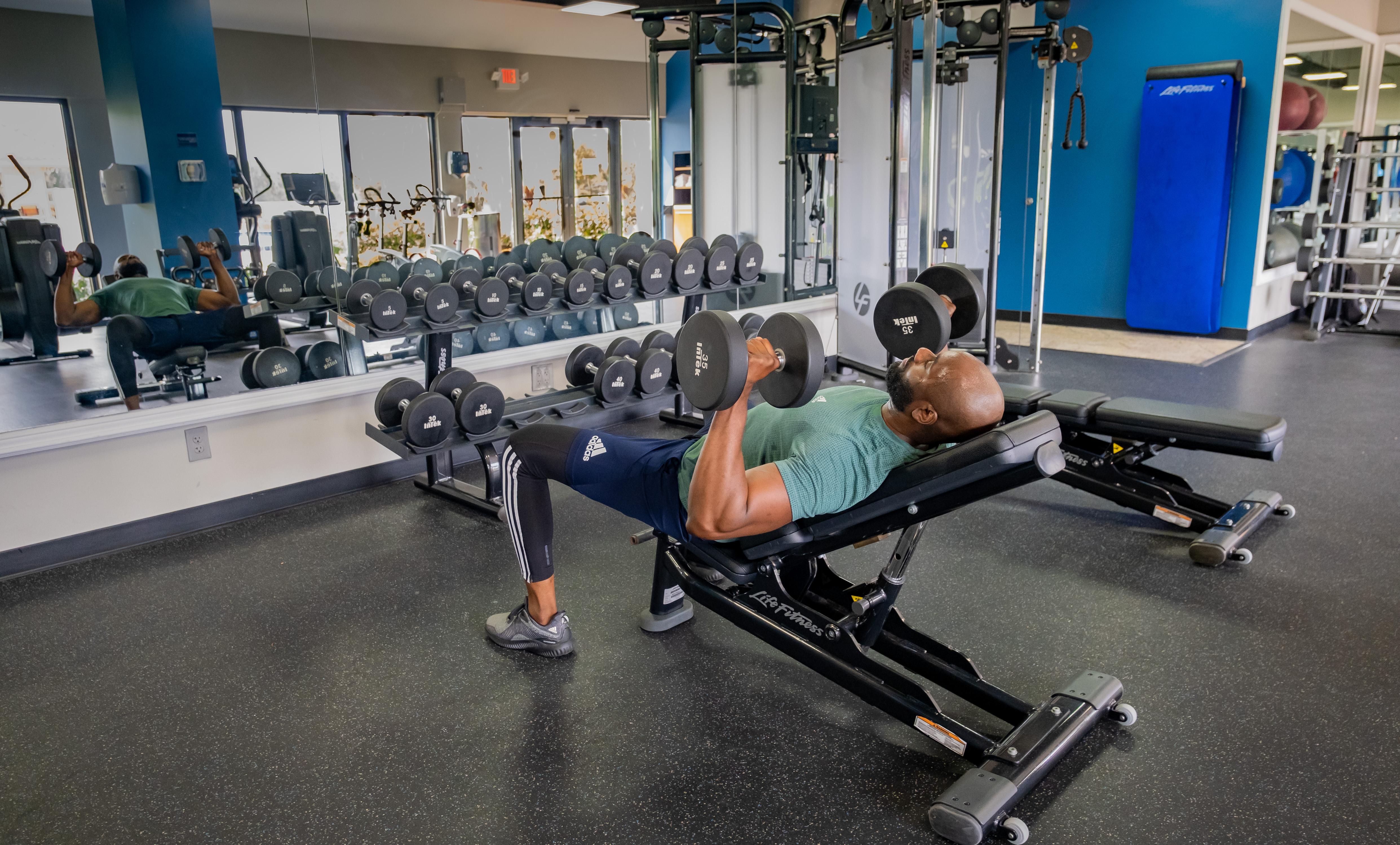 Man Lifting Weights in Fitness Center
