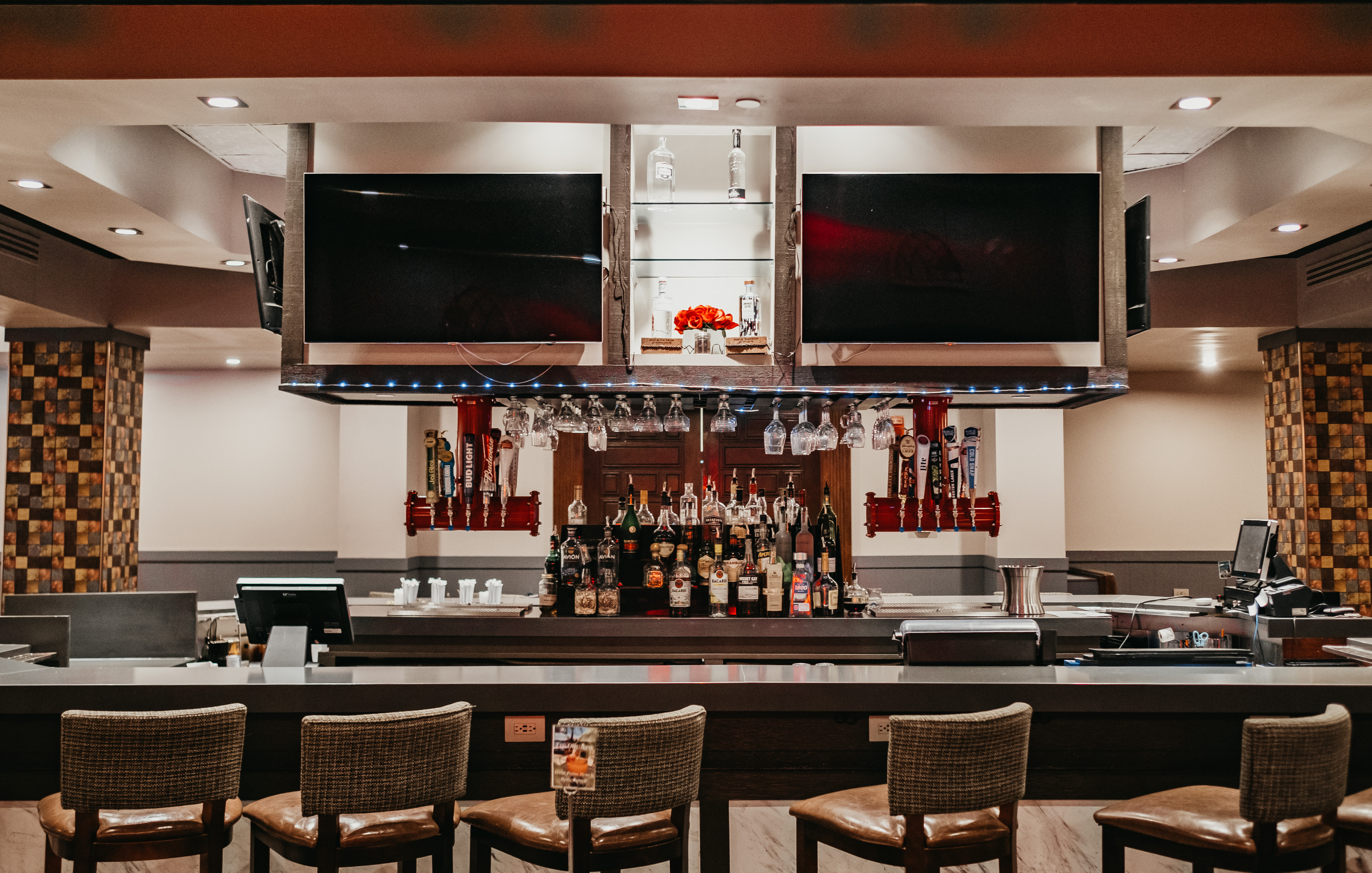 Bar area with stools and TV