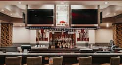 Bar area with stools and TV