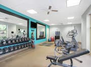 Fitness Center with Elliptical, Dumbbells, Mirrors, and Room Technology