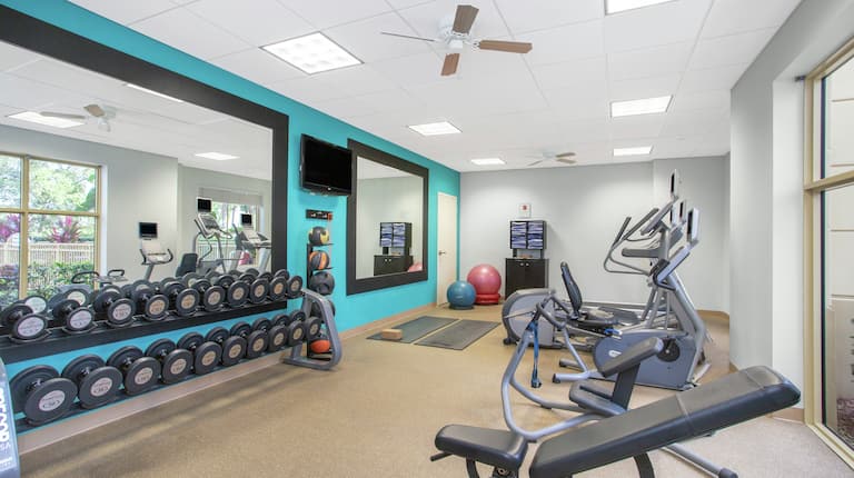 Fitness Center with Elliptical, Dumbbells, Mirrors, and Room Technology
