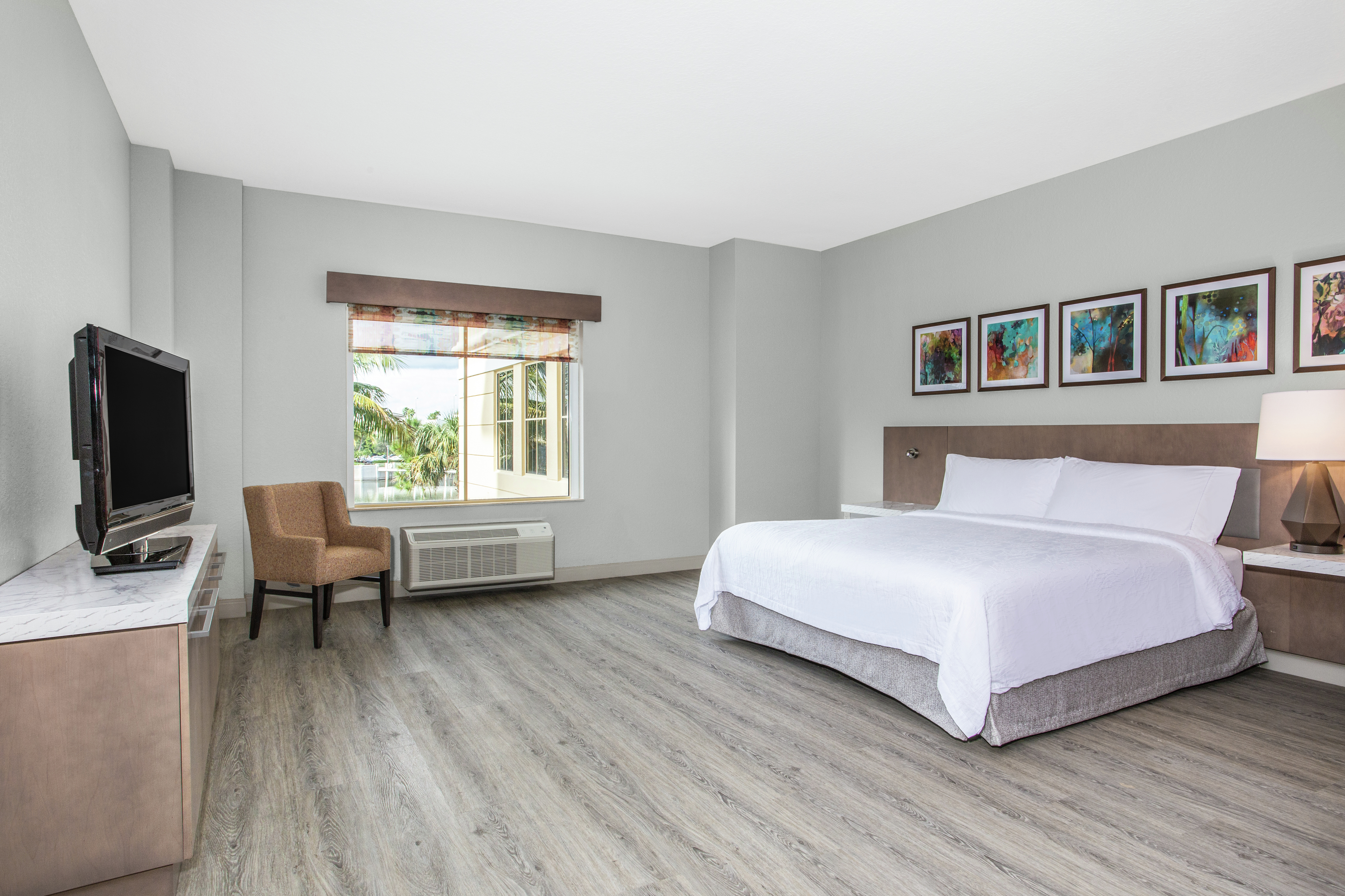 Accessible King Suite Guestroom with Bed, Outside View, Lounge Area, and Room Technology