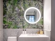 Bathroom Vanity Area with Round Lit Mirror