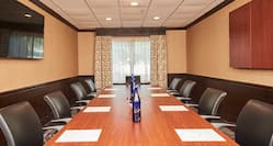 Boardroom Meeting Table with Office Chairs and Wall Mounted HDTV