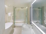 Presidential suite bathroom with tub and shower