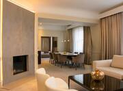 King presidential suite living room with fireplace and dining table