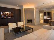 King presidential suite living room with wall mounted TV and fireplace