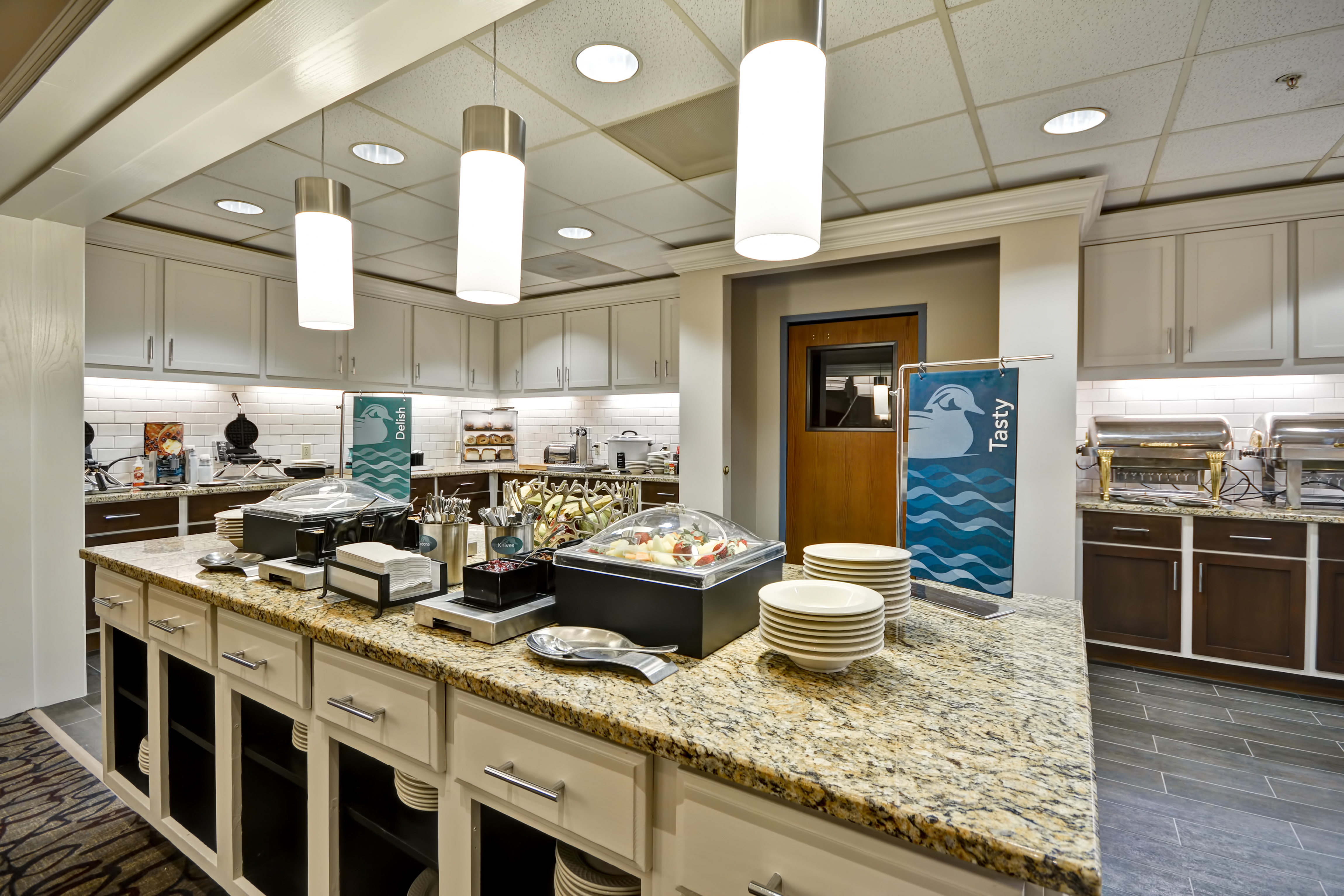 Breakfast serving area with coffee, juice, snacks, and dining amenities