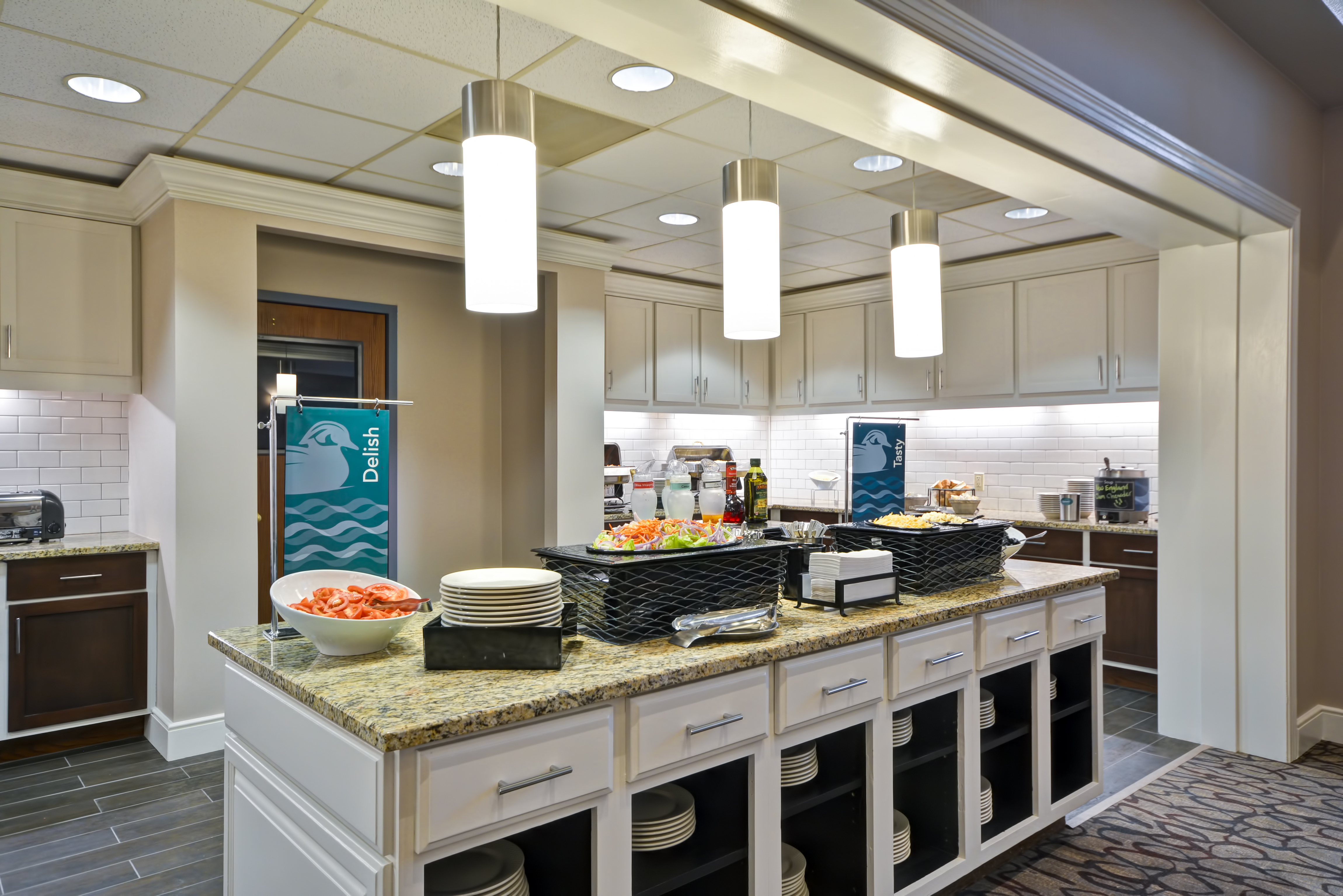 Food and Beverage serving area with food selections coffee, juice, snacks, vegetables, and dining amenities