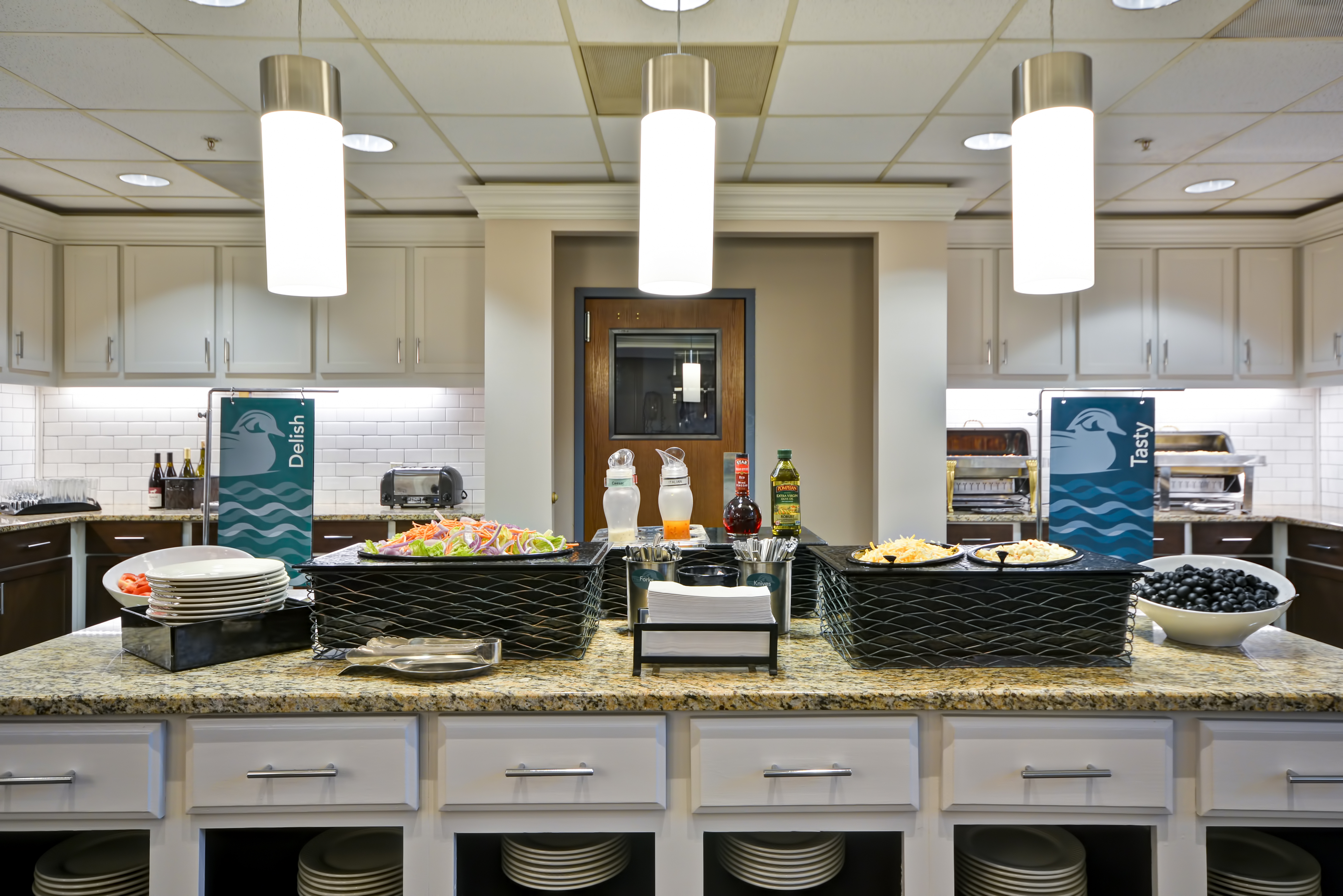 Dinner serving area with buffet trays, food and wine selections, and dining amenities