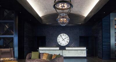 Reception area with desk and large clock on wall