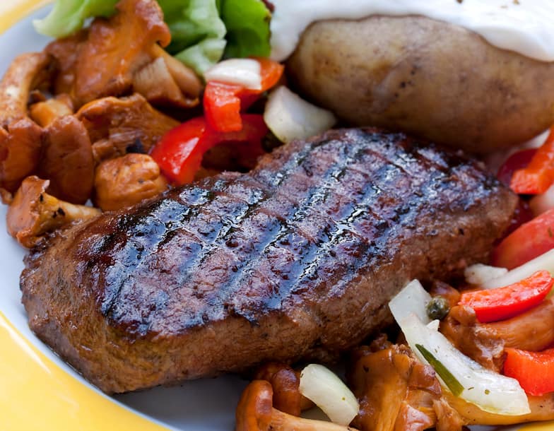 Plated Steak with Vegetables and Baked Potato