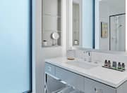 Glass Door Shower Reflected in Vanity Mirror in Corner King Guest Room Bathroom