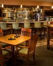 Tables With Candles, Chairs, TVs and Counter Seating at Fully Stocked PressNW Bistro & Bar