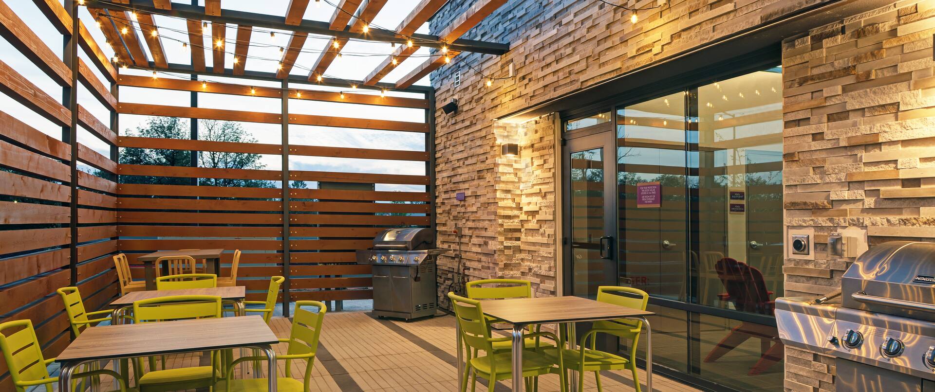 outdoor patio with grills at dusk