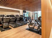 Light, bright fitness centre with wood decor and cardio machines