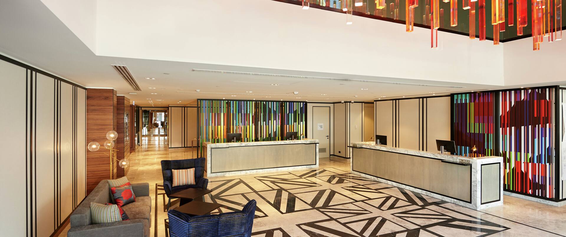 Lobby with Architectural Detail, Couches, Pillows, and Room Technology