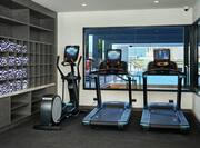 Fitness Center with Treadmills, Elliptical, and Pool View