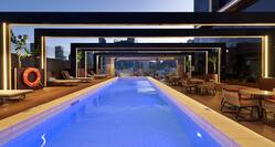 Outdoor Swimming Pool in Twilight with Tables and Chairs