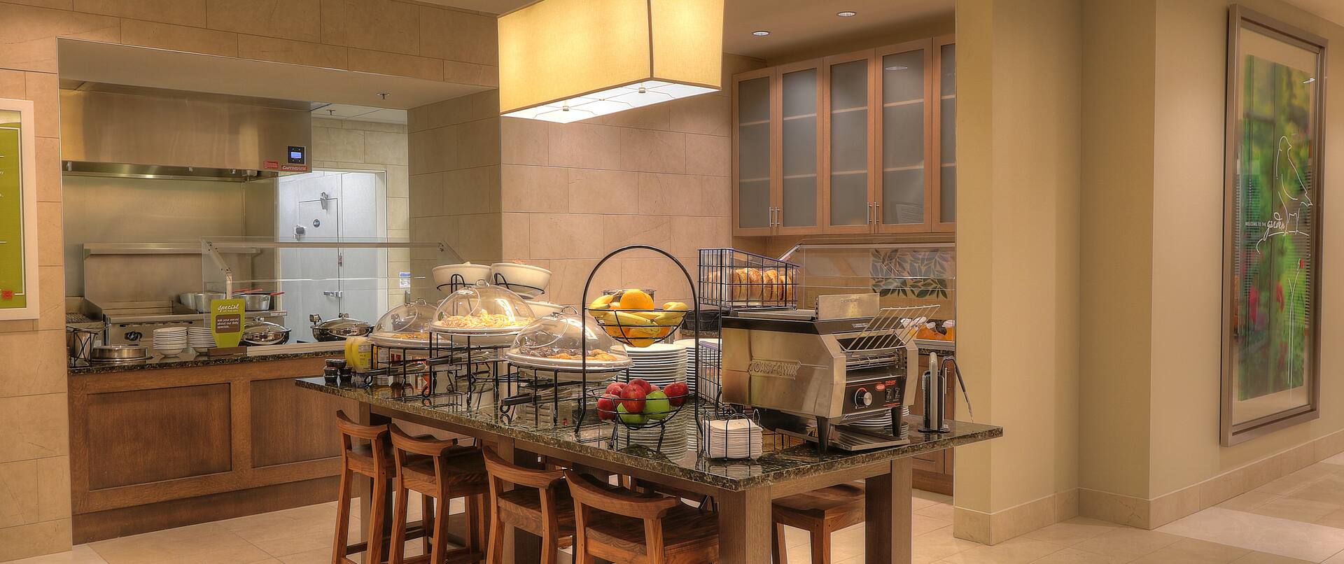Wide view of Breakfast Service Area With Plates, Utensils, Hot and Cold Buffet Items