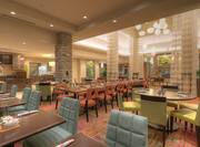 TV, Food Service Area, Dining Tables and Chairs in Garden Grille and Bar With View of Long Drapes, Decorative Lighting, and Beverage Stations in Lobby