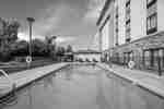 Alternate view of the outdoor pool, pool deck, and hotel exterior.