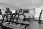 Exercise Bike, Treadmills and Weights in Fitness Center with TV