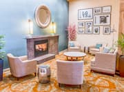 Soft Seating, Tables, Wall Art, and Fireplace in Lobby Lounge Area