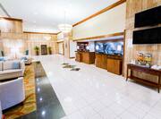 Spacious Lobby With TV, Beverage Station, Lounge Seating, Snack Shop, and Front Desk
