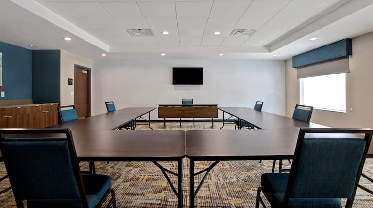 meeting space with tables seating and television