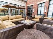 Bar Patio Tables With Umbrellas, Chairs and Soft Seating by Fire Pit