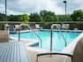 Outdoor Swimming Pool Area with Chairs and Table