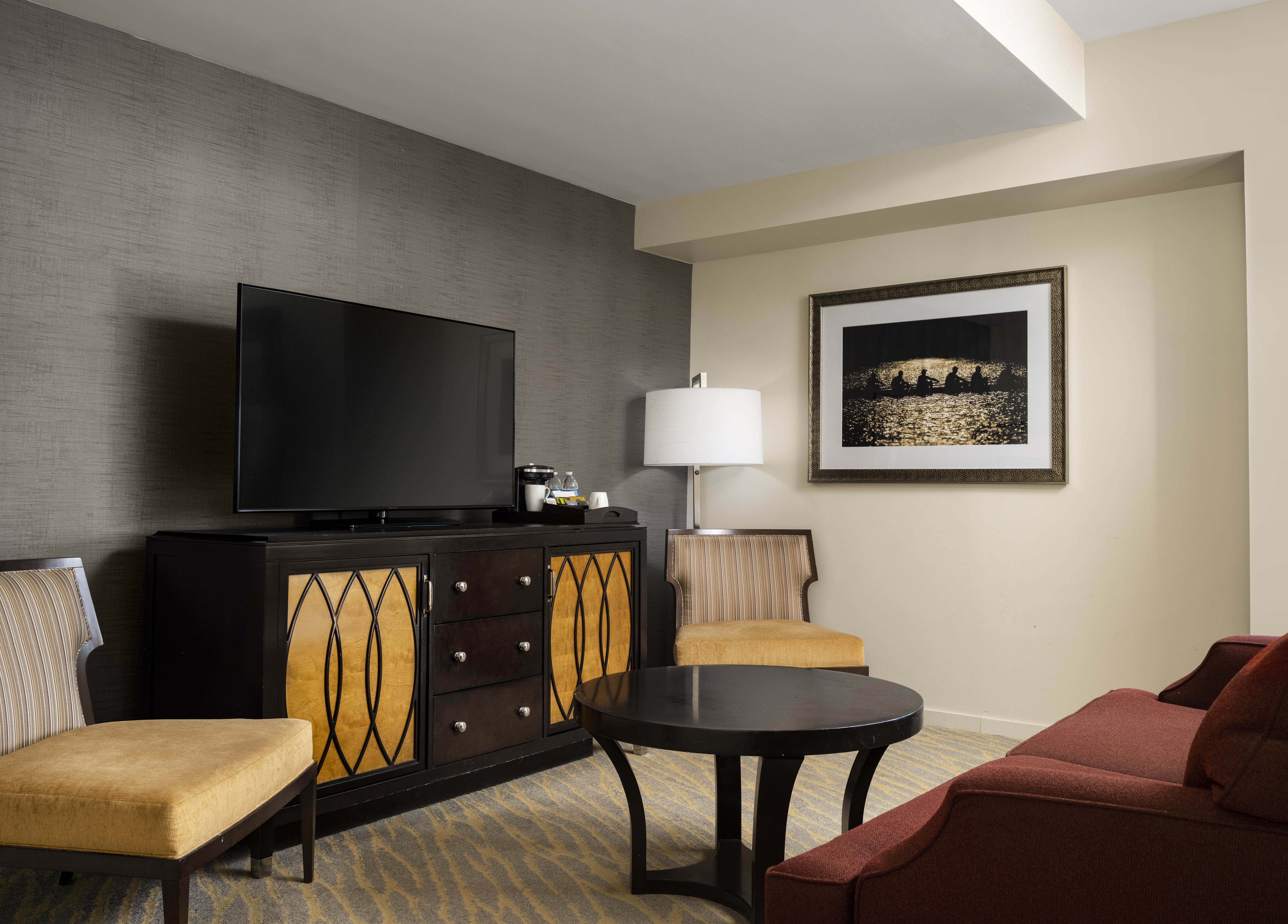 living area in suite with tv