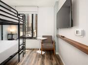 Bunk Beds in Guest Room with City View HDTV and Chair