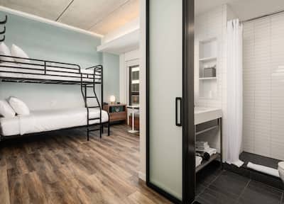 Bunk Beds in Hotel Guest Room And Partial View of Bathroom