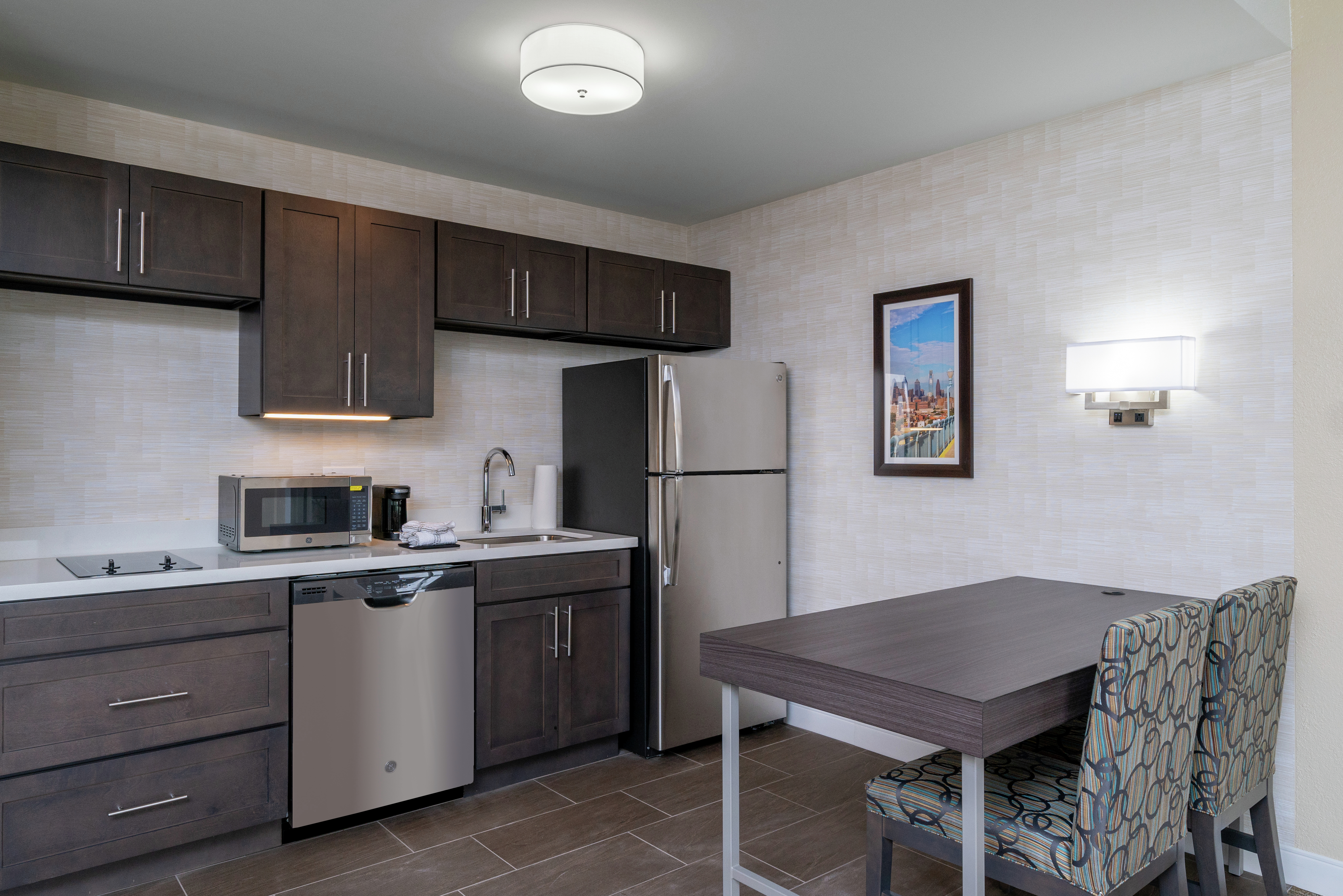 Guest Suite Kitchen Area with Dining Table, Chairs, Refridgerator, Microwave and Dishwasher