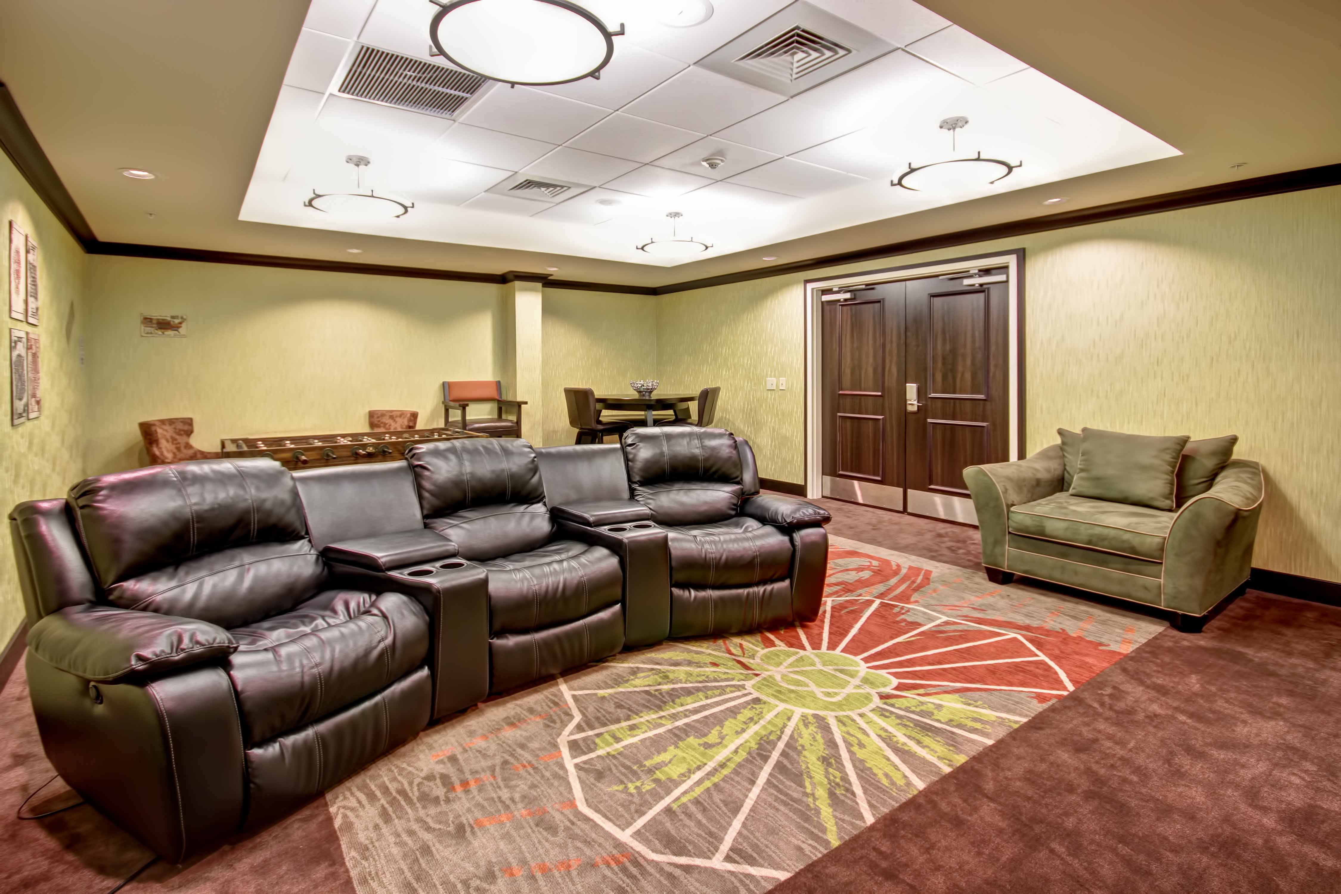 Game room with theater-style recliner chairs