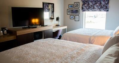 Two Queen Beds Guest Bedroom with HDTV and Work Desk