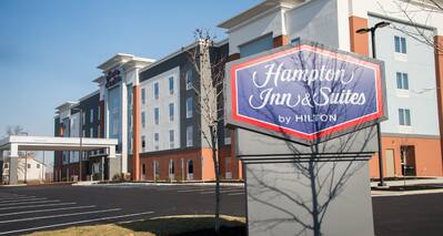 Hotel Building Exterior with Hampton Inn & Suites by Hilton Sign at Day