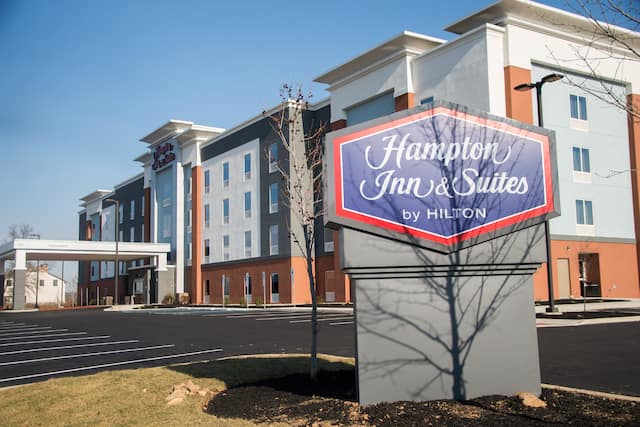 Hotel Building Exterior with Hampton Inn & Suites by Hilton Sign at Day