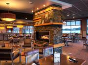 Dining Tables, Chairs, Wall Art, Fireplace, Windows, and Food Service Area in Restaurant