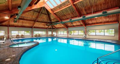 Windows, Skylight, Loungers, Table and Chairs by Indoor Heated Swimming Pool and Hot Tub
