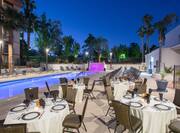 Poolside Restaurant Dining Tables and Chairs with a View Palm Trees