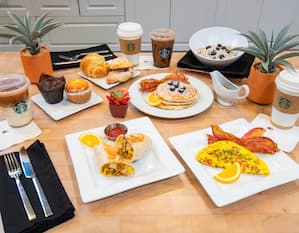 breakfast plates display, pancakes, omelet, breakfast burrito, oatmeal, pastries, coffees