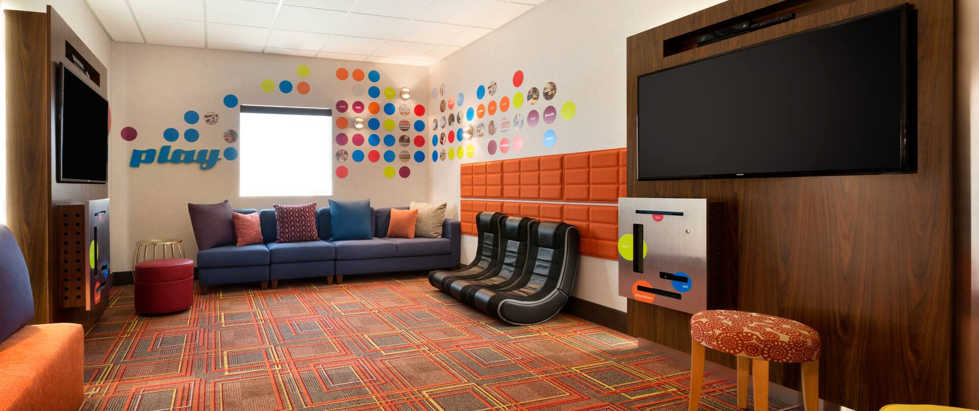 Game Room With Window, Two TVs, Colorful Seating, and Three Gaming Rockers