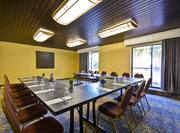A meeting room with u shaped table and chairs