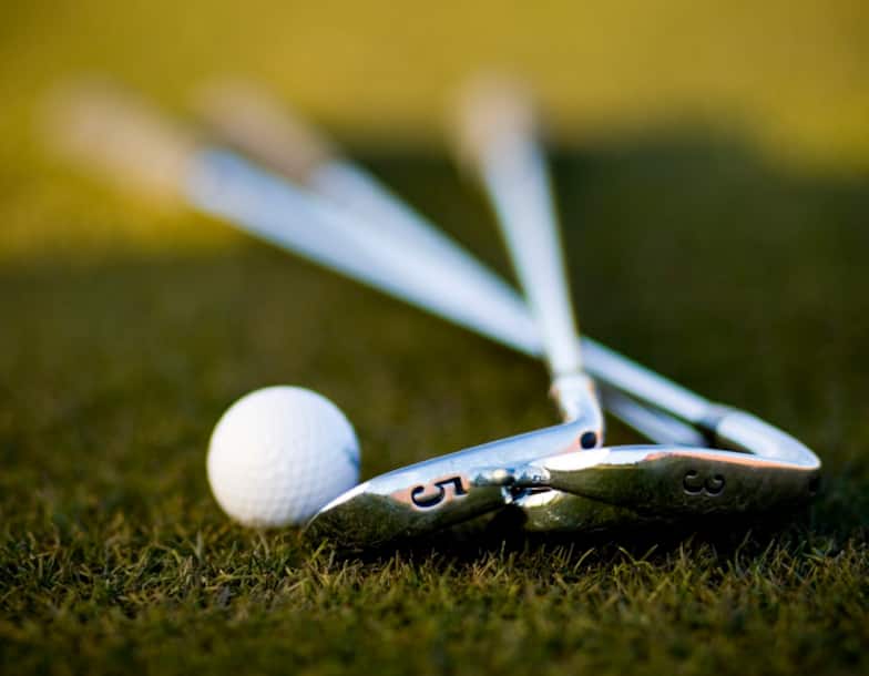 Golf Clubs and Ball Lying on Green