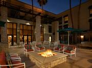Outdoor Seating Area with Fireplace and Armchairs at Night