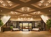 Long Drapes, Valet Booth, Soft Seating, Sign Above Front Entrance Doors to View of Front Desk and Lobby Lounge Seating